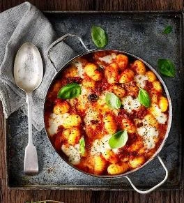 Five easy dinner recipes for busy weeknights laid out on a kitchen table