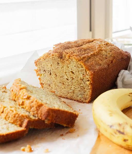 A few ripe bananas and a dusting of cinnamon beside it.
