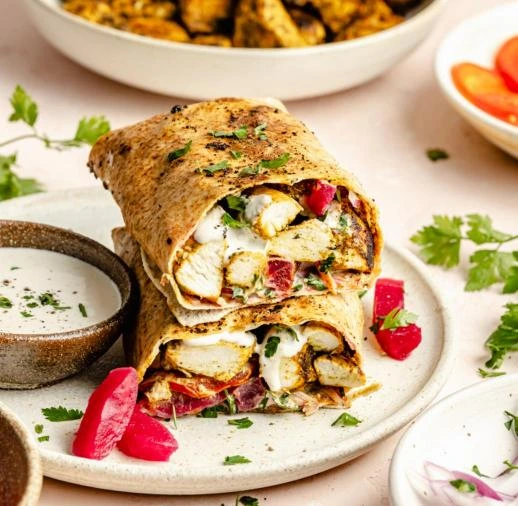 Homemade chicken shawarma with garlic sauce served in warm pita bread with fresh vegetables